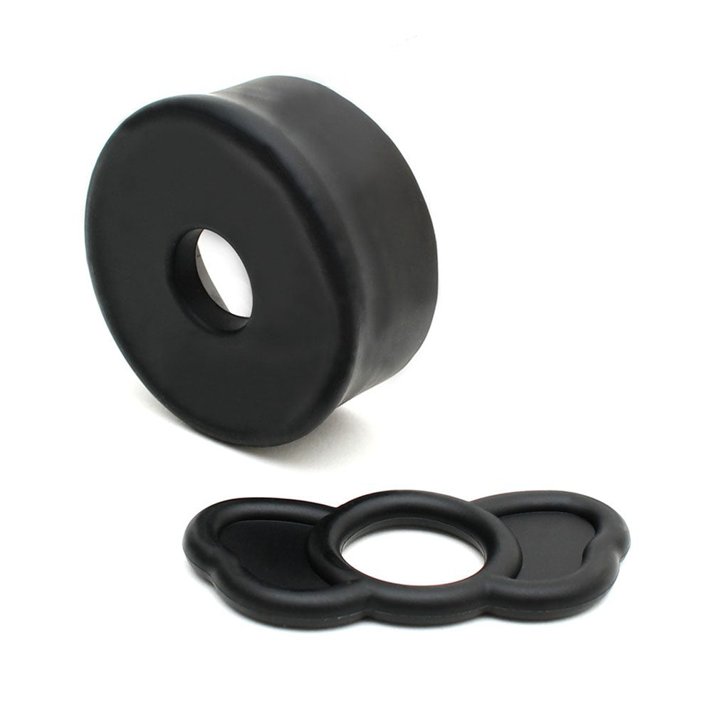 Two black rubber bushings on a white background