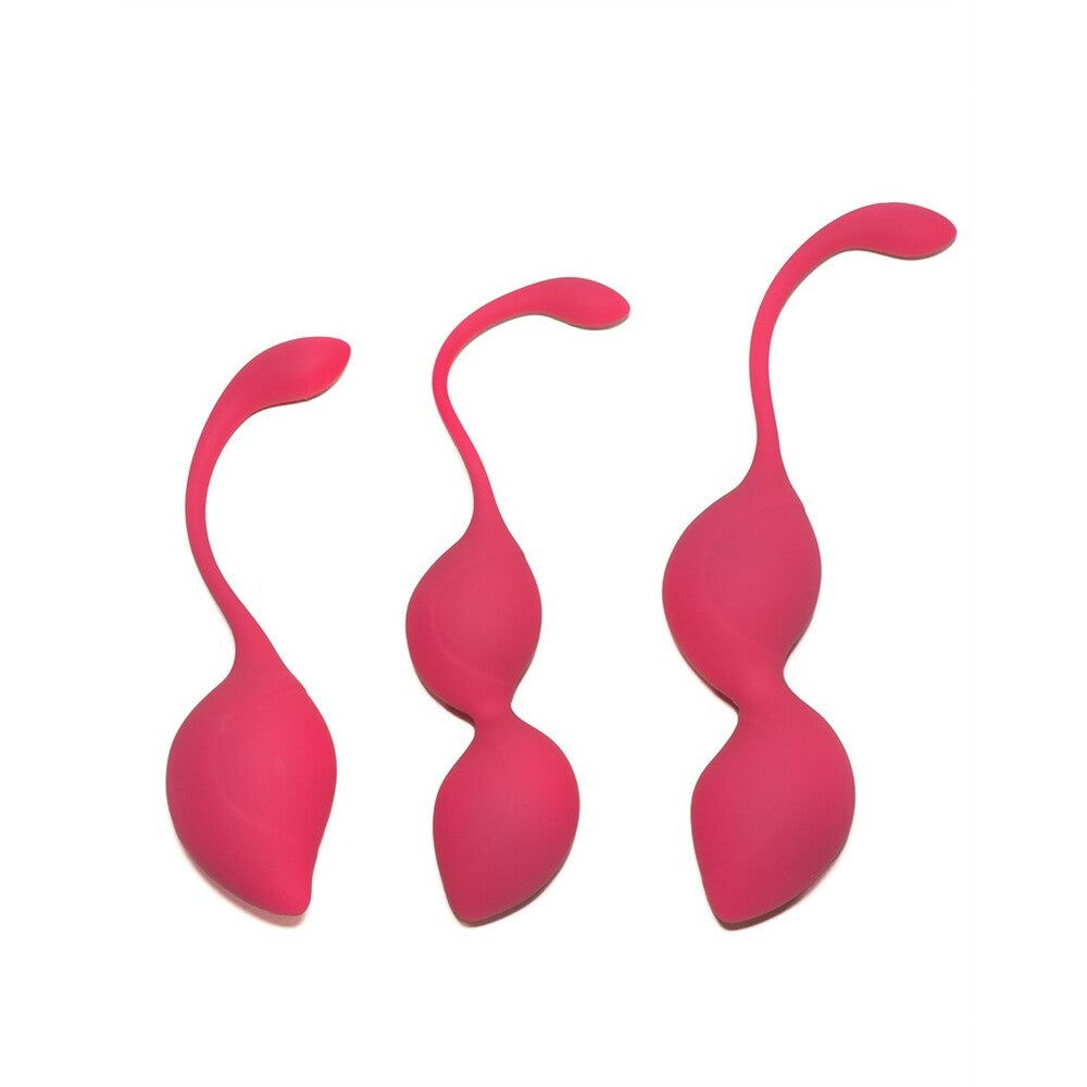 The image shows three pink silicone kegel balls, each with a loop handle for easy removal. The balls come in different sizes and are designed to be used as part of a Kegel exercise training set.