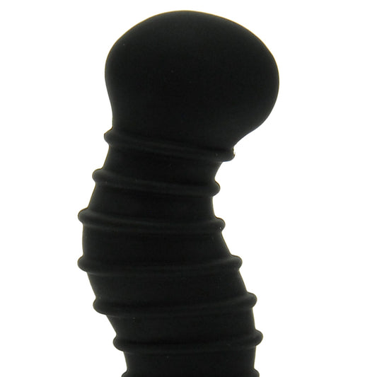 Black silicone butt plug on a white background