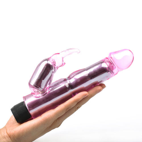 A pink, translucent rabbit vibrator being held in a hand. The device has a sleek, curved design with two motor sections.