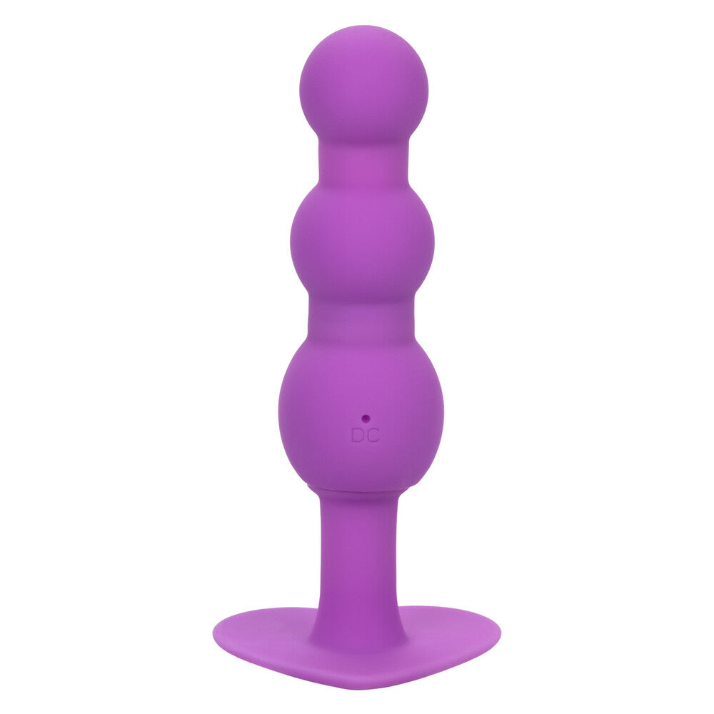Purple silicone butt plug on a white background