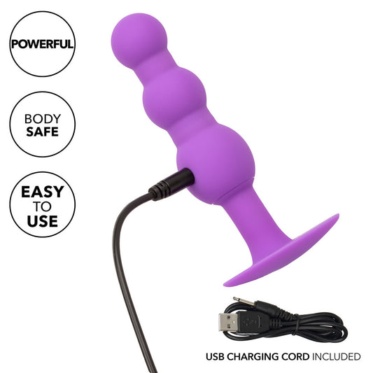 Purple silicone device with USB charging cord on a white background