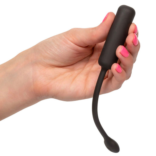 Black curved object held in a hand on a white background