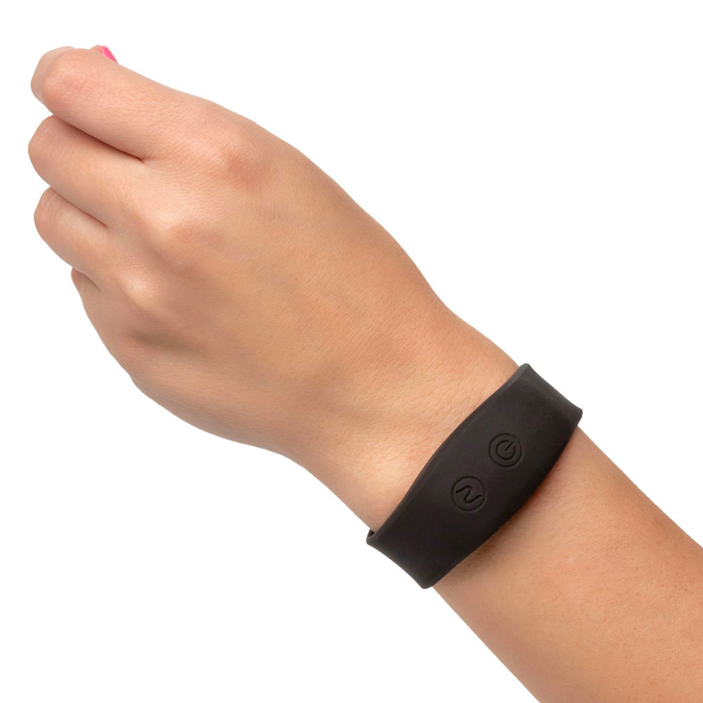 Black wristband on a wrist against a white background