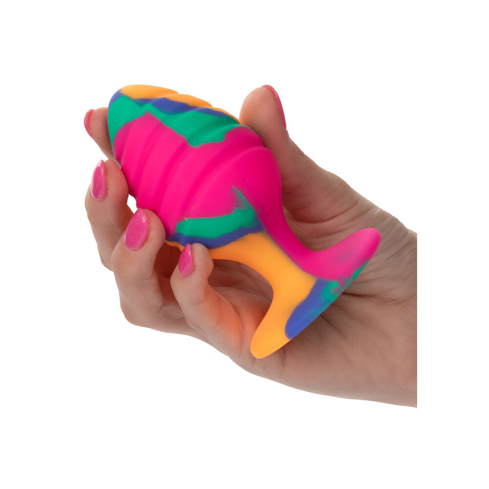 Colorful fish-shaped stress reliever toy held in a hand on a white background