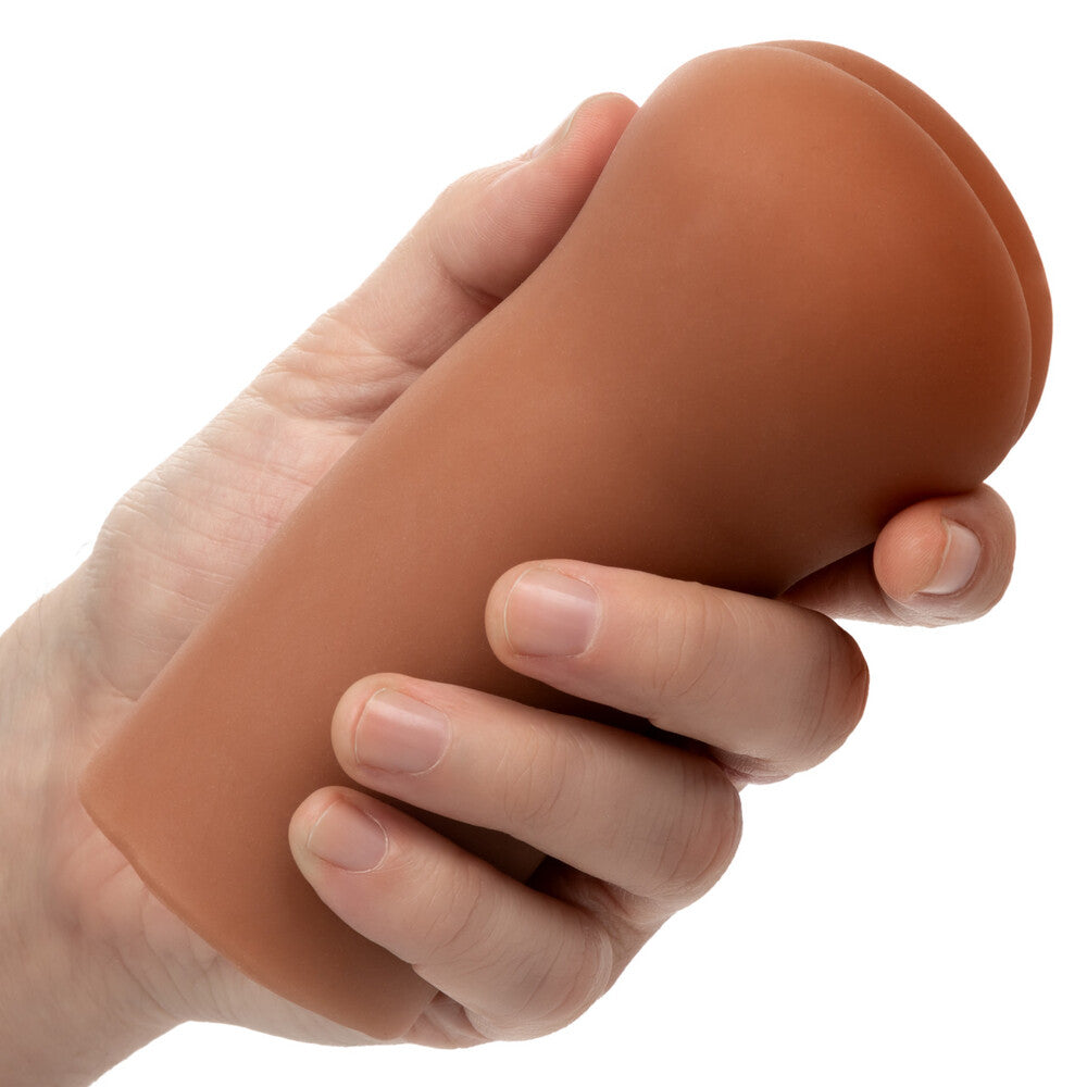 Hand holding a brown silicone sleeve on a white background