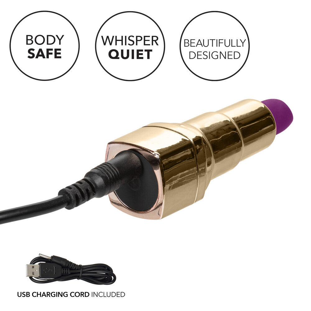 A gold lipstick-shaped vibrator with a deep purple tip, branded 'Bad Bitch' on the shiny casing.