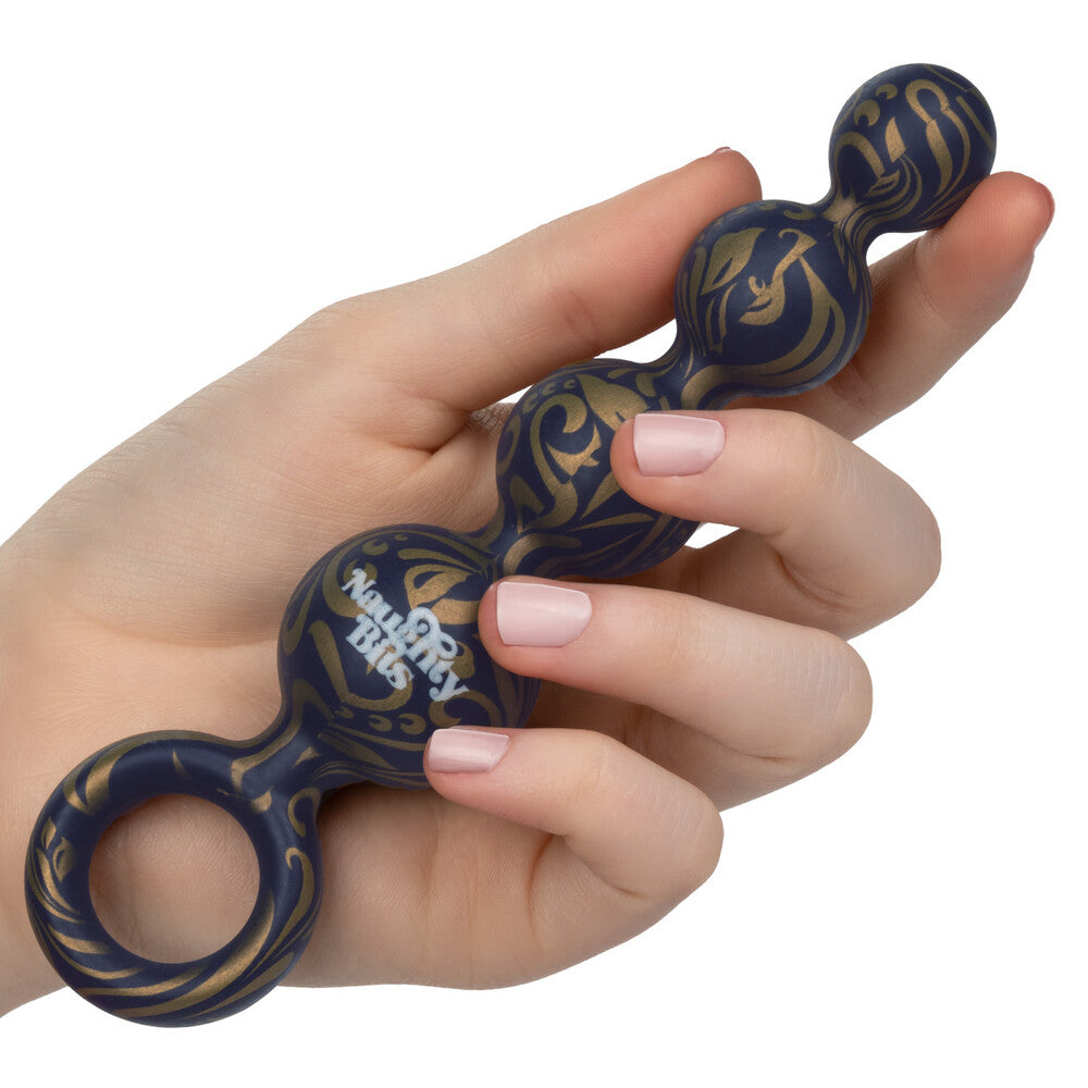 Hand holding a blue and gold fidget spinner with 'Ninety Percent' branding.