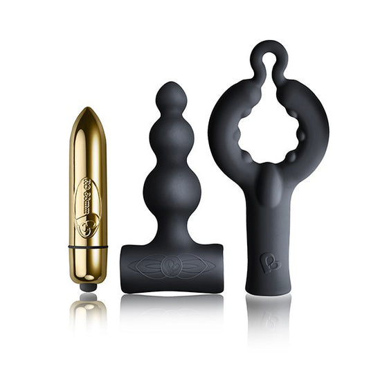The image shows a black silicone T-shaped base and a golden bullet vibrator, indicating the kit includes these items for couple's pleasure.