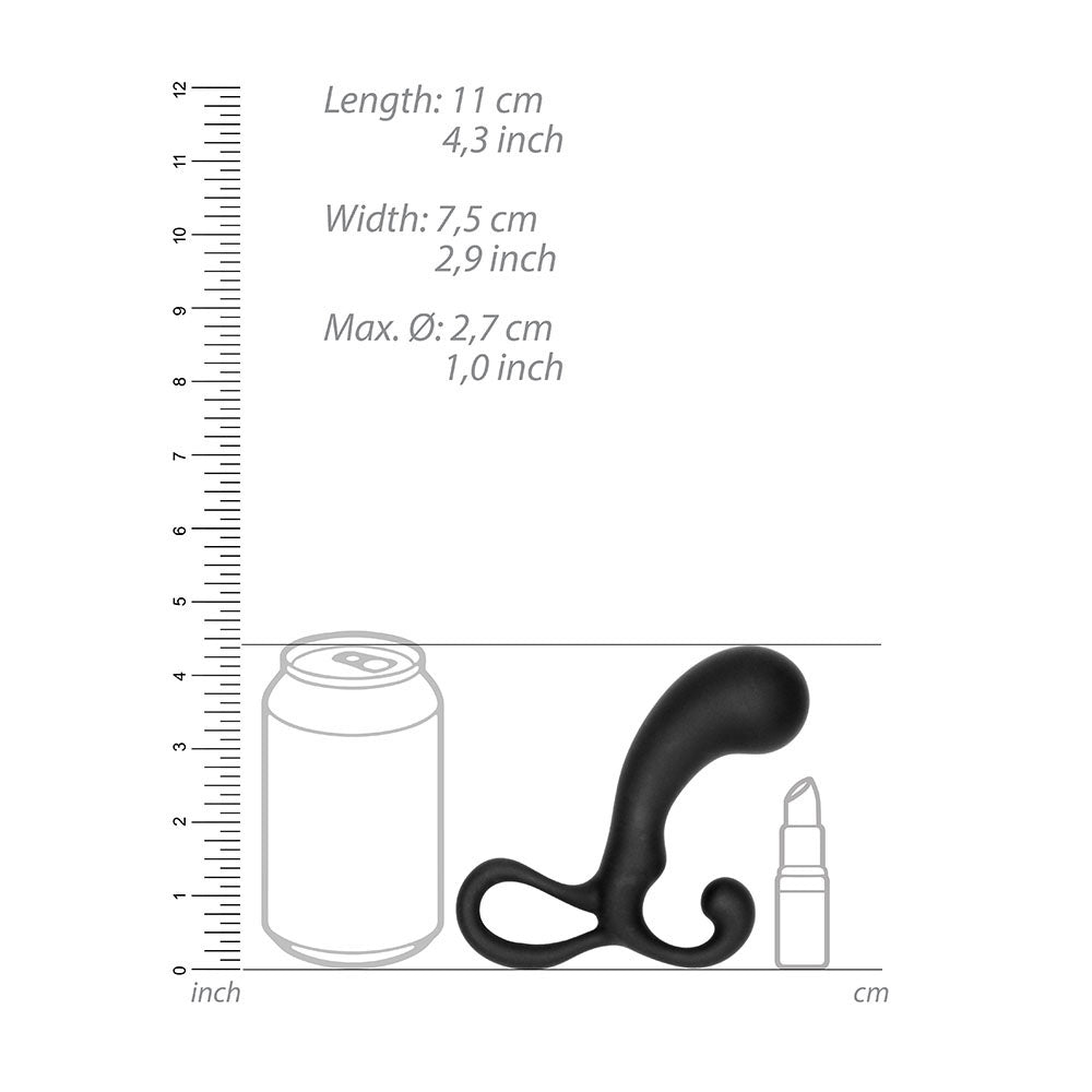Black curved object with measurements relative to a can, lipstick, and ruler on a white background