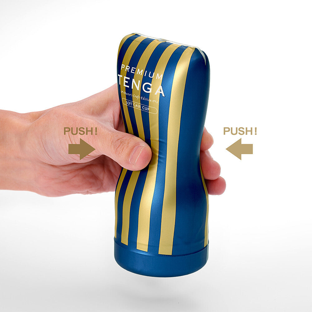 Blue and yellow striped container with 'Tenga' branding, held by a hand on a white background.
