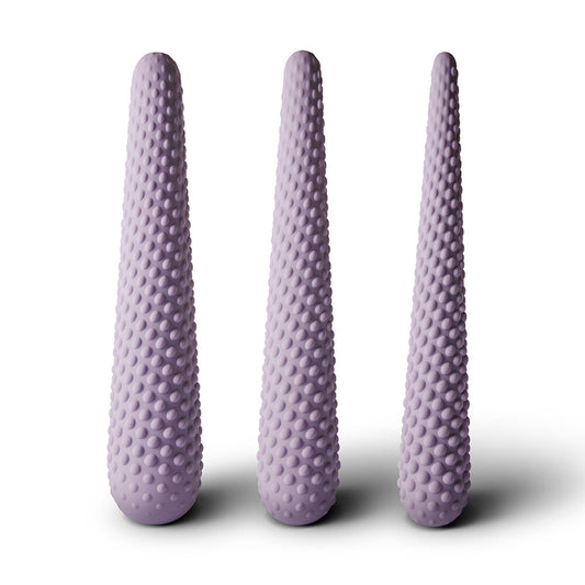 A set of three purple silicone dilators of varying sizes, each with a textured surface.