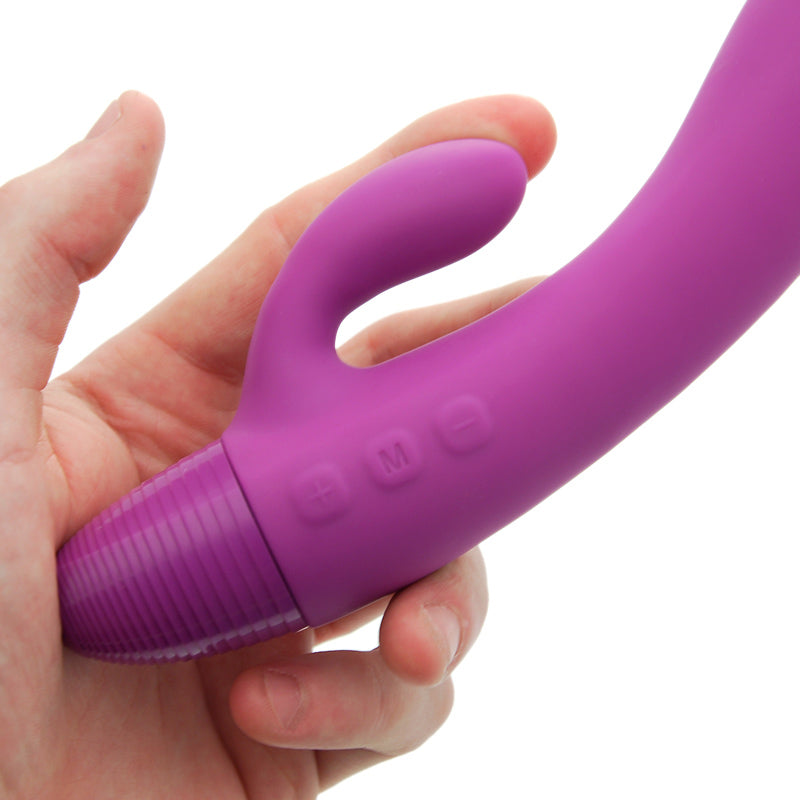 Purple handheld device held in a hand against a white background