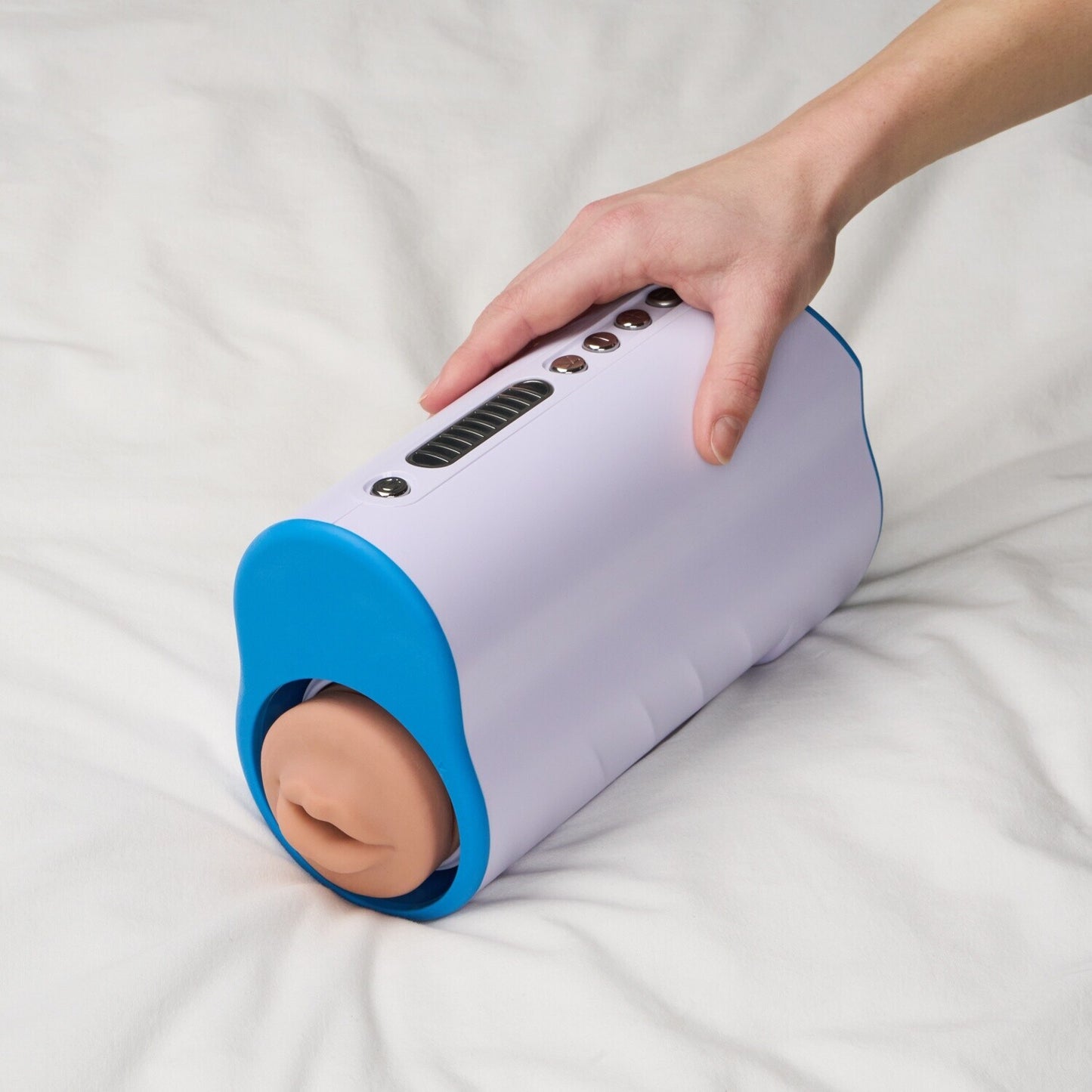 Hand holding a cylindrical device with a blue base and white top on a white surface.