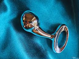 Metallic bottle opener on a blue fabric background