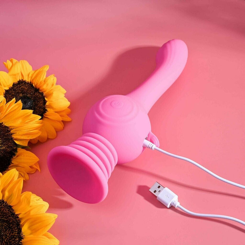 Pink silicone product with USB cable on a pink background with sunflowers