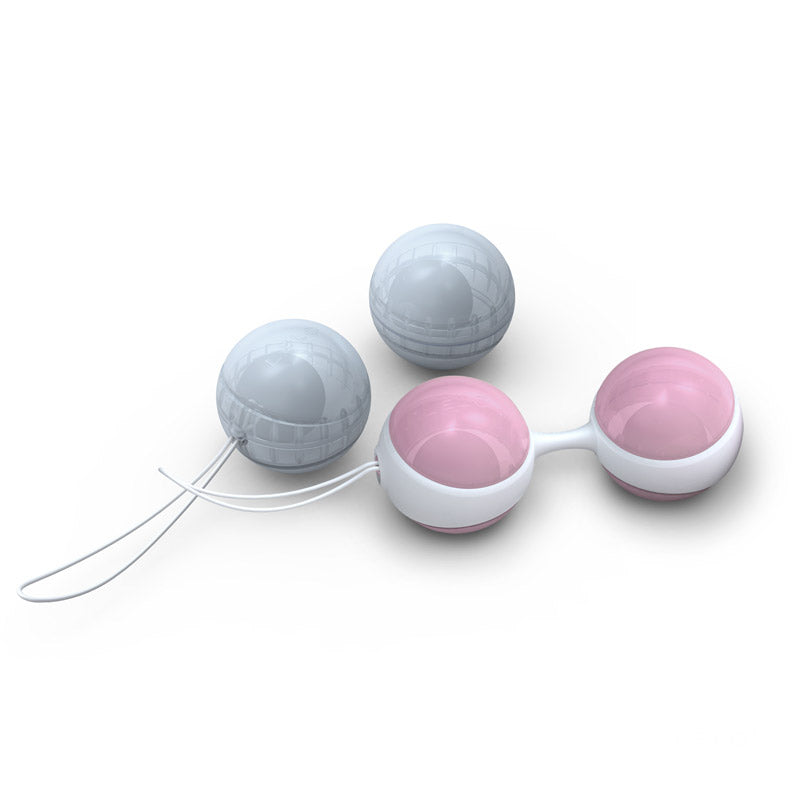 White device with gray and pink spherical components on a white background