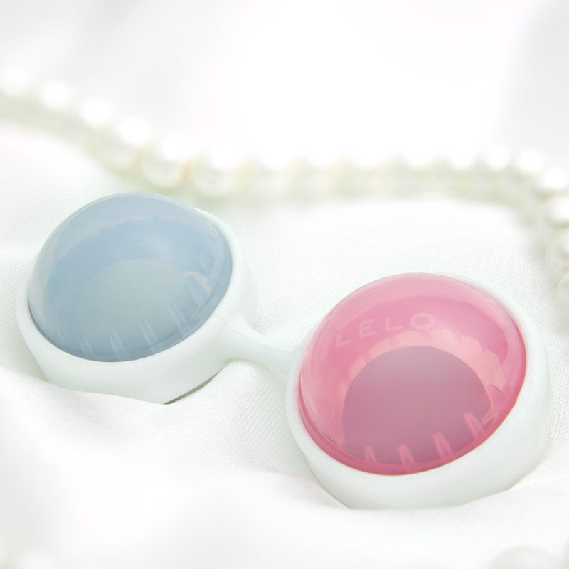 Contact lens case with blue and pink lenses on a white background