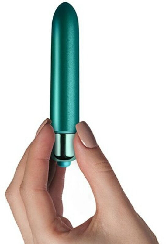 Teal cylindrical object held by a hand against a white background