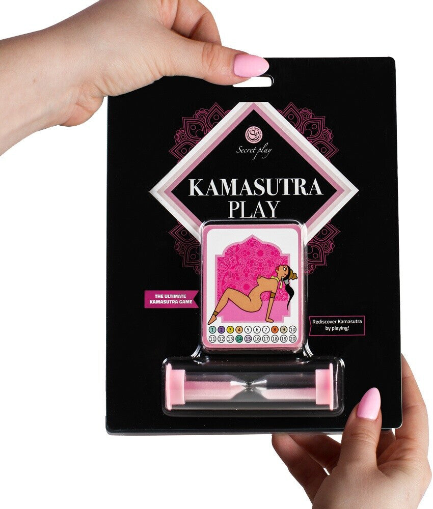 Kamasutra Play packaging held by a hand with pink nail polish on a white background