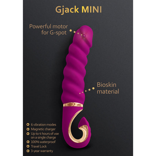 A purple, cylindrical mini vibrator with a curved end, featuring a thick, ridged design and a gold accent ring near the base.