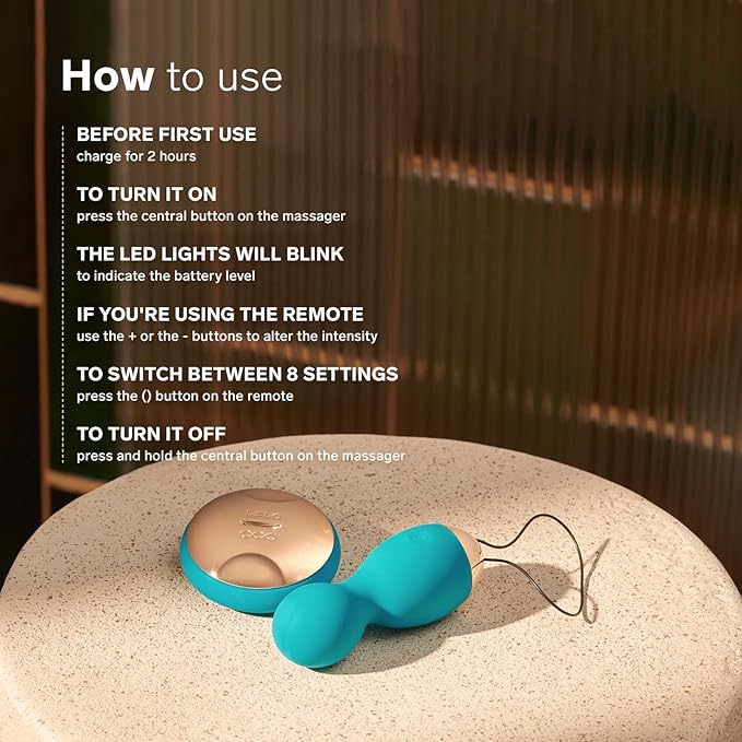 Turquoise handheld massager on a beige surface with usage instructions.