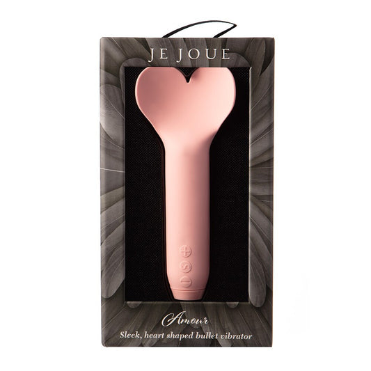A hand holding a pink, heart-shaped bullet vibrator.