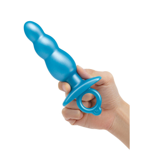 Hand holding a blue toy with a white background
