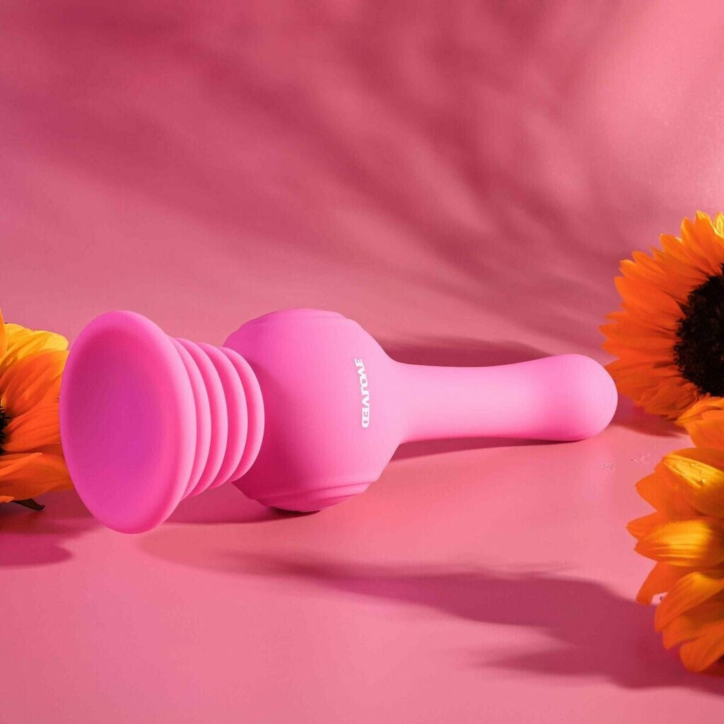 Pink silicone product with 'Glorious' branding on a pink background with sunflowers.