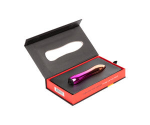 A hand holding a pink and metallic bullet vibrator.